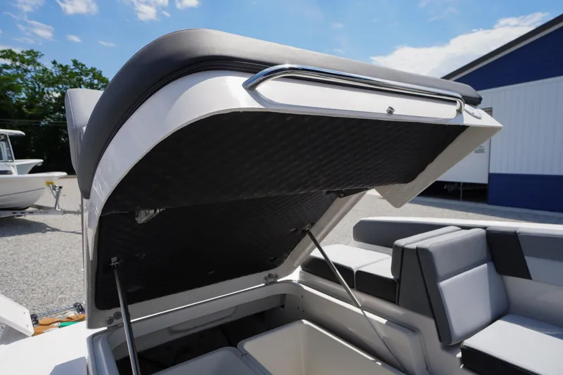 Slide: The Image of 2026 Chaparral SSX 4 boat with open storage compartment, showcasing sleek interior design. - 56