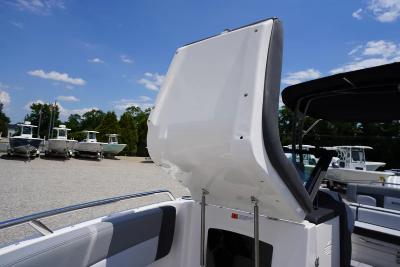 Slide: The Image of 2026 Chaparral SSX 4 boat interior with open storage compartment, sunny day. - 16
