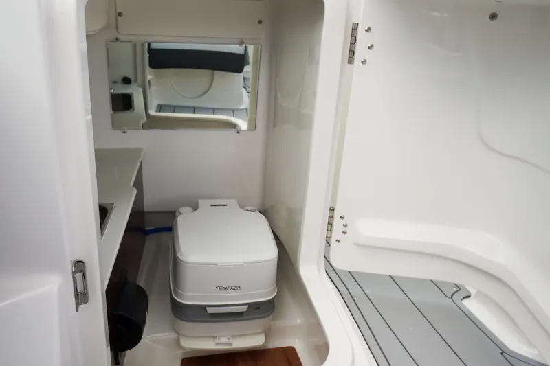 Slide: The Image of 2026 Chaparral SSX 4 boat interior with compact toilet and mirror. - 43