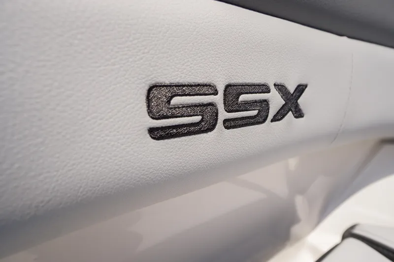 Slide: The Image of 2026 Chaparral SSX 4 interior detail with embroidered logo on white upholstery. - 1