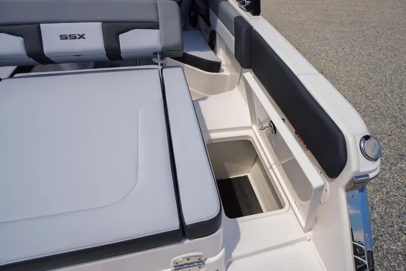 Slide: The Image of 2026 Chaparral SSX 4 boat interior with cushioned seating and storage compartment. - 60