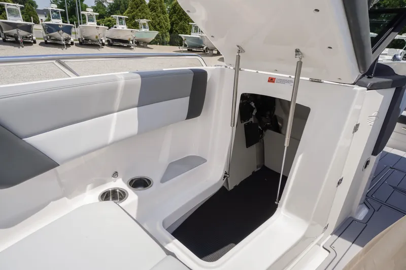 Slide: The Image of 2026 Chaparral SSX 4 boat interior with open storage compartment and seating area. - 15