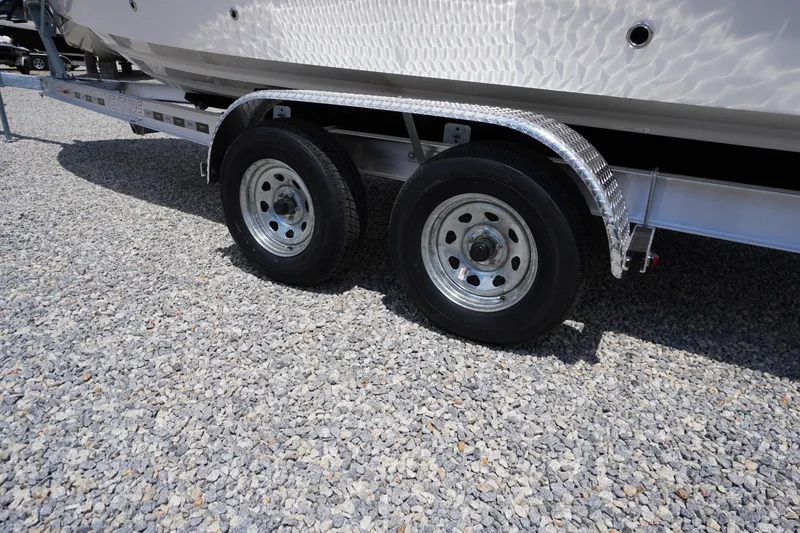 Slide: The Image of Trailer wheels of a 2026 Chaparral SSX 4 boat on gravel surface. - 4