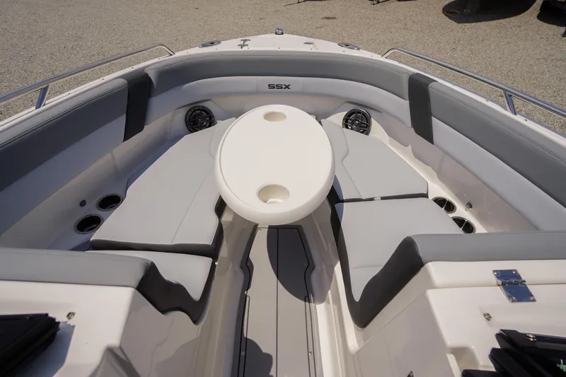 Slide: The Image of 2026 Chaparral SSX 4 boat interior with cushioned seating and round table. - 6