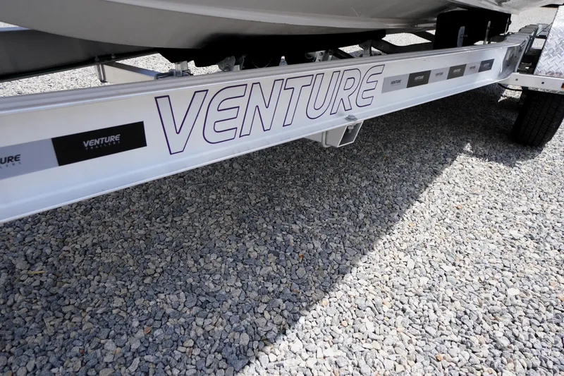 Slide: The Image of Trailer for 2026 Chaparral SSX 4 boat on gravel surface. - 3