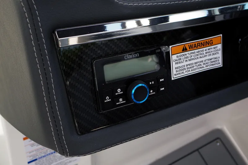 Slide: The Image of 2026 Chaparral SSX 4 dashboard with Clarion audio system and safety warning label. - 31