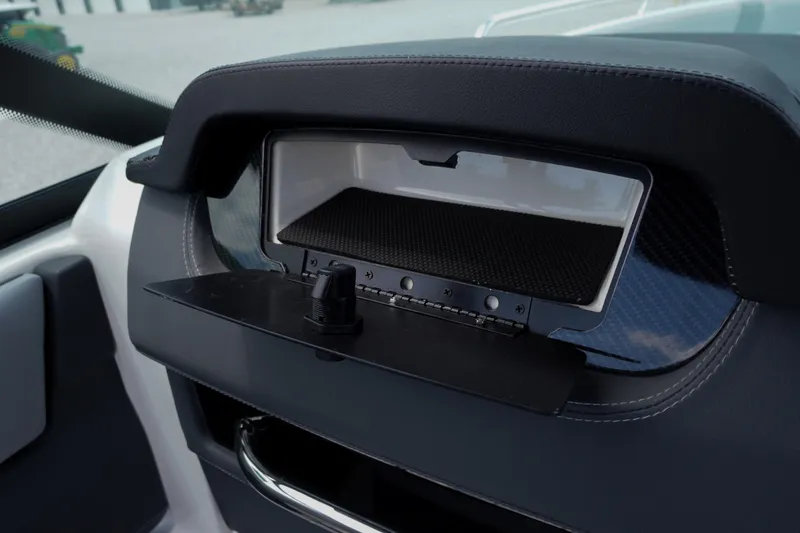Slide: The Image of Dashboard compartment of 2026 Chaparral SSX 4 boat, featuring sleek design and storage space. - 38