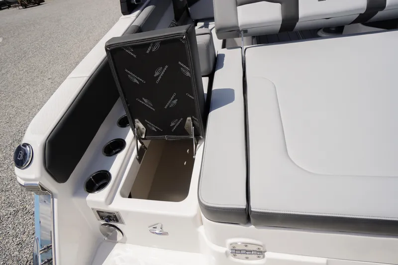 Slide: The Image of 2026 Chaparral SSX 4 boat interior with open storage compartment and cup holders. - 59