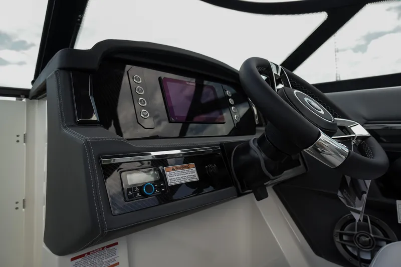 Slide: The Image of 2026 Chaparral SSX 4 boat dashboard with steering wheel and control panel. - 25