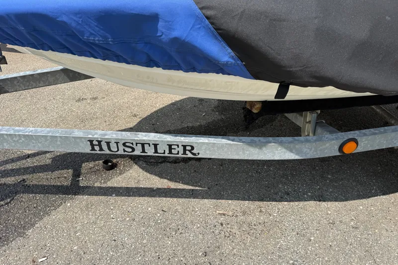 Slide: The Image of 2005 Honda Aquatrax F-12 on Hustler trailer, covered with blue and black tarp. - 11