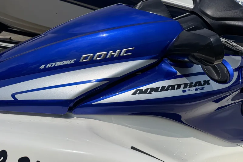 Slide: The Image of 2005 Honda Aquatrax F-12 jet ski, blue and silver, featuring 4-stroke DOHC engine. - 2