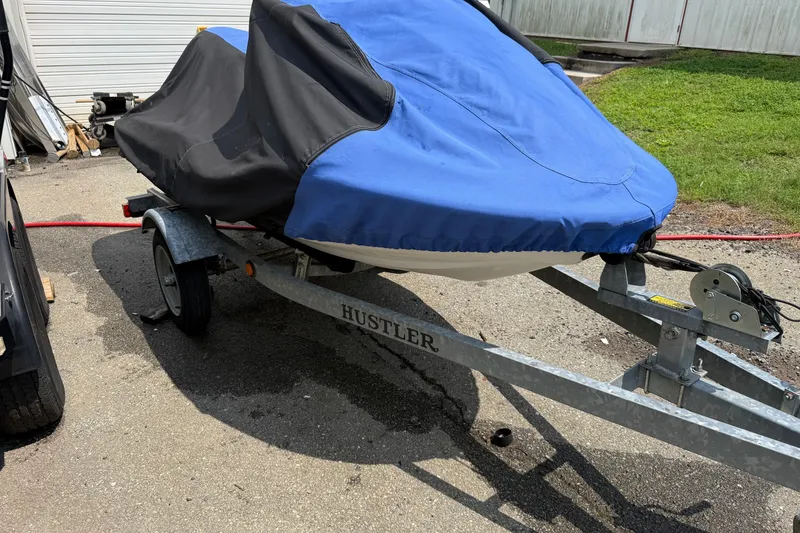 Slide: The Image of 2005 Honda Aquatrax F-12 jet ski covered on a trailer in a driveway. - 14
