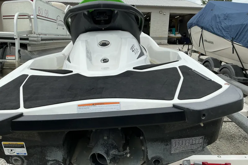Slide: The Image of 2013 Sea-Doo GTI SE 130 jet ski on trailer, rear view, parked outdoors. - 6