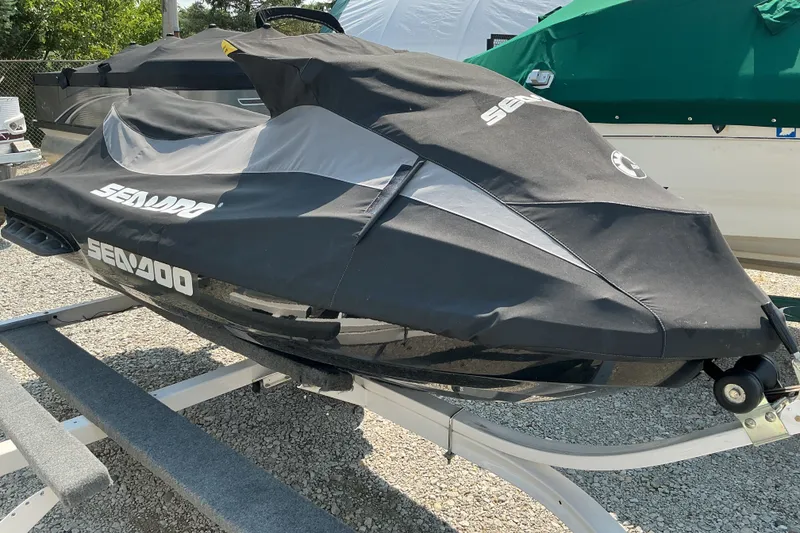 Slide: The Image of 2013 Sea-Doo GTI SE 130 jet ski covered, parked on a trailer. - 11