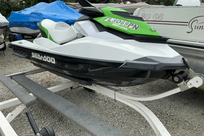 Slide: The Image of 2013 Sea-Doo GTI SE 130 jet ski on trailer, white and green design. - 10