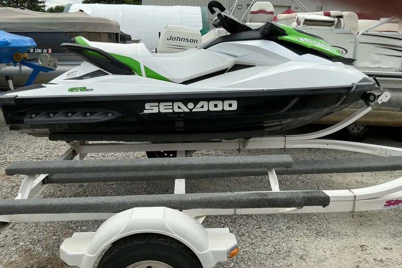 Slide: The Image of 2013 Sea-Doo GTI SE 130 jet ski on trailer, white and green design. - 9