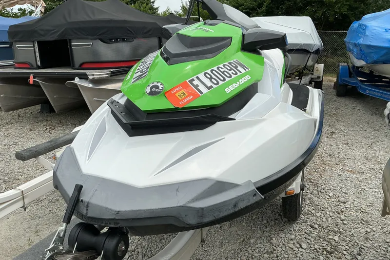 Slide: The Image of 2013 Sea-Doo GTI SE 130 jet ski on trailer, parked outdoors. - 3