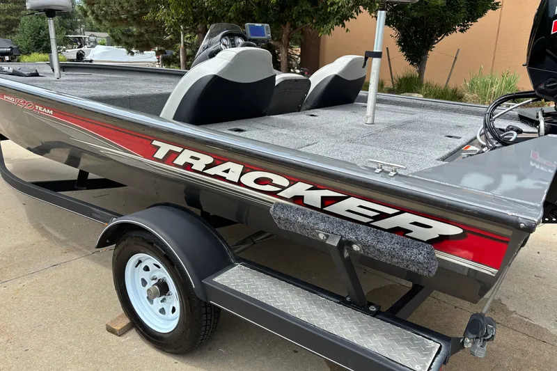 Slide: The Image of 2018 Tracker Pro Team 190 TX boat on trailer, side view with logo and seating. - 11