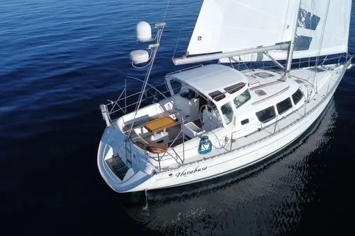 Slide: The Image of 1999 Jeanneau Sun Odyssey 40 DS sailing on calm waters, showcasing sleek design and spacious deck. - 4