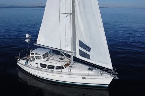 Slide: The Image of 1999 Jeanneau Sun Odyssey 40 DS sailboat cruising on calm blue waters. - 1