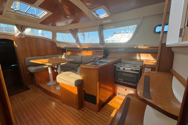 Slide: The Image of Interior of 1999 Jeanneau Sun Odyssey 40 DS sailboat with wood finish and seating area. - 15