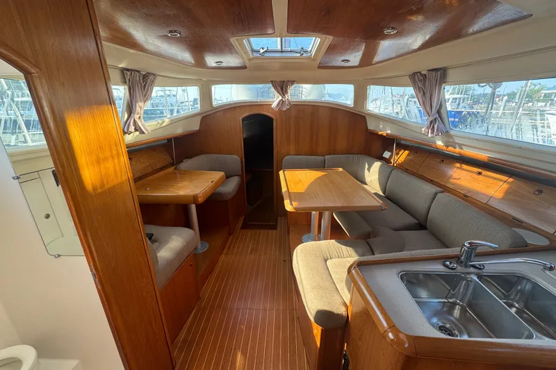 Slide: The Image of Interior of 1999 Jeanneau Sun Odyssey 40 DS sailboat with wood finish and seating area. - 18