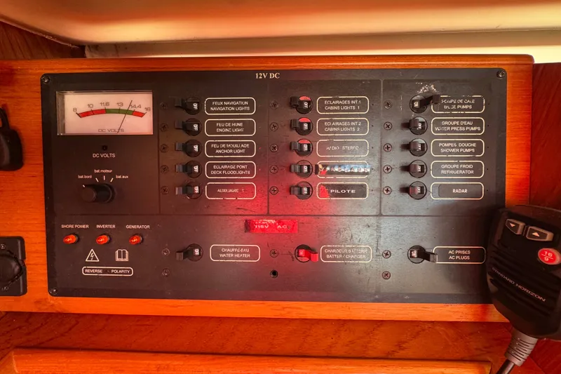 Slide: The Image of Control panel of a 1999 Jeanneau Sun Odyssey 40 DS sailboat, featuring various switches and gauges. - 10