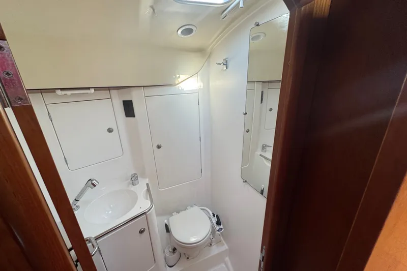 Slide: The Image of Bathroom interior of 1999 Jeanneau Sun Odyssey 40 DS yacht, featuring sink and toilet. - 8