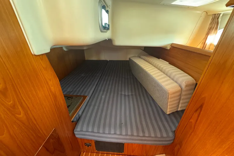 Slide: The Image of Cozy cabin interior of 1999 Jeanneau Sun Odyssey 40 DS sailboat with striped bedding. - 14