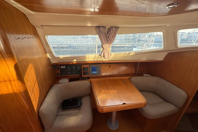 Slide: The Image of Cozy interior of 1999 Jeanneau Sun Odyssey 40 DS sailboat with wooden table and seating. - 6