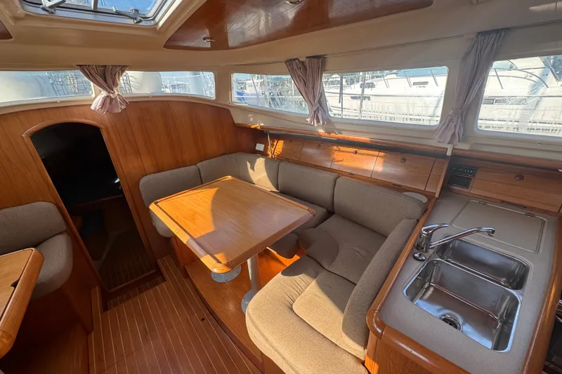 Slide: The Image of Interior of 1999 Jeanneau Sun Odyssey 40 DS sailboat with cozy seating and kitchenette. - 16