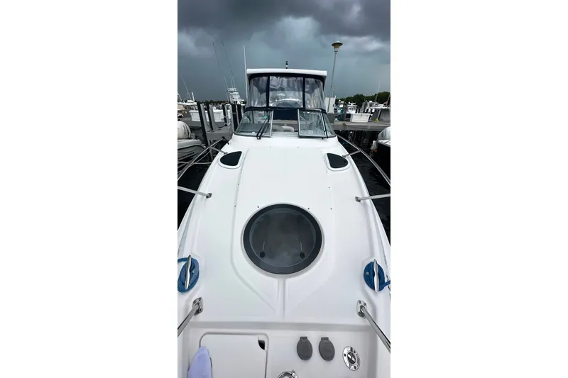 Slide: The Image of 2021 Regal 28 Express boat docked under stormy skies. - 26