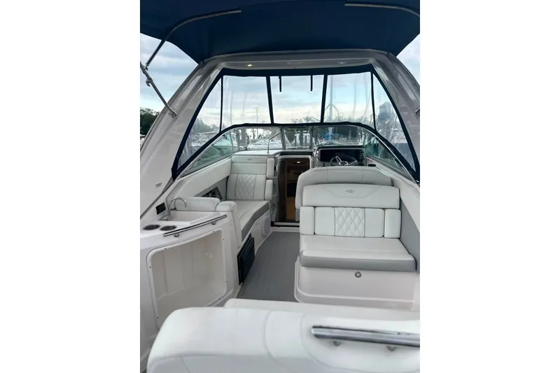 Slide: The Image of 2021 Regal 28 Express boat interior with white seating and blue canopy. - 3