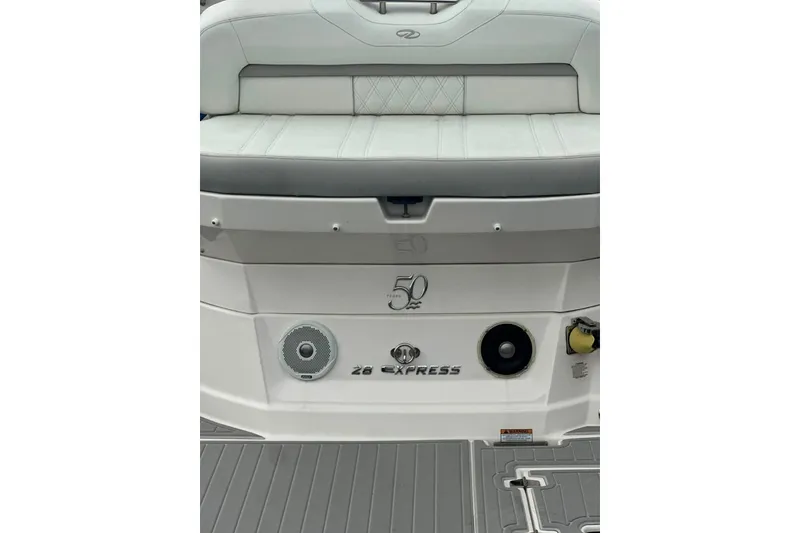 Slide: The Image of 2021 Regal 28 Express boat stern with seating and speaker details. - 13