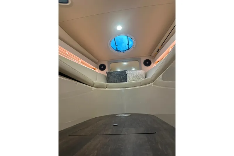 Slide: The Image of Interior cabin of 2021 Regal 28 Express boat with seating and porthole. - 23