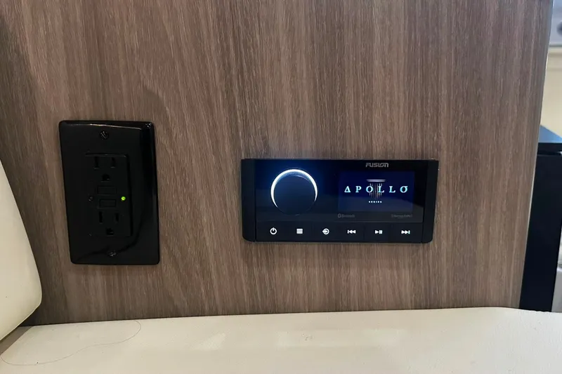 Slide: The Image of 2021 Regal 28 Express interior with Fusion Apollo stereo and power outlet. - 27