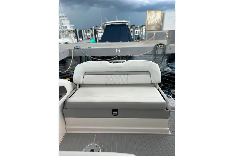 Slide: The Image of 2021 Regal 28 Express boat interior with cushioned seating at dock. - 39