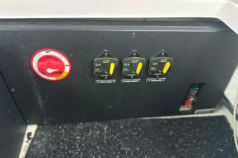 Slide: The Image of Control panel of a 2021 Regal 28 Express boat with switches and circuit breakers. - 45