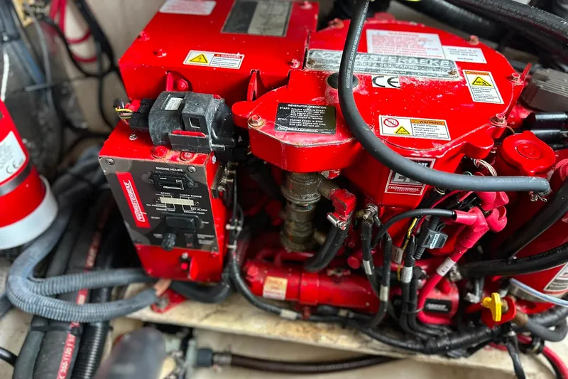 Slide: The Image of Engine compartment of a 2021 Regal 28 Express boat, featuring red mechanical components. - 38