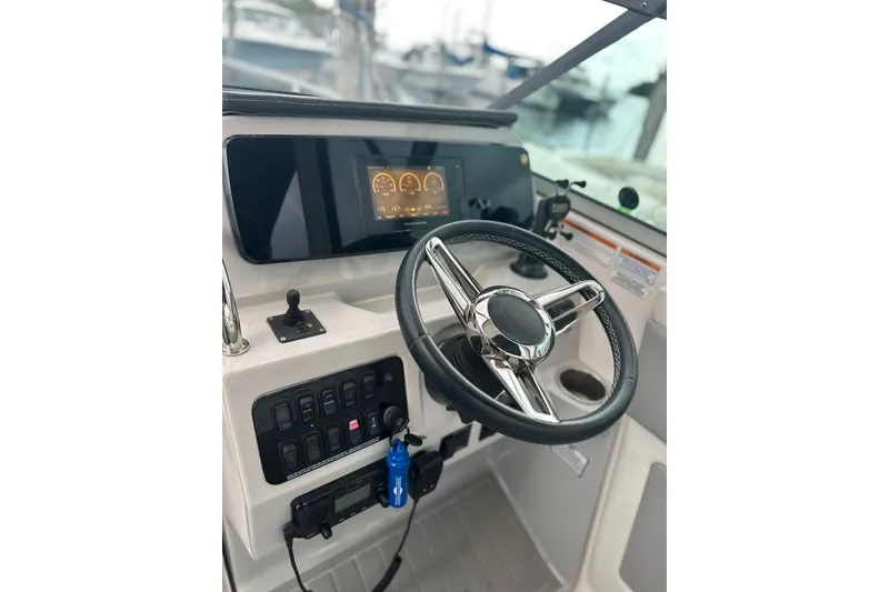 Slide: The Image of Helm of 2021 Regal 28 Express boat with modern steering and control panel. - 12