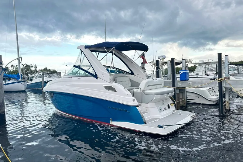 The Image of 2021 Regal 28 Express boat docked at marina under cloudy sky. - 0