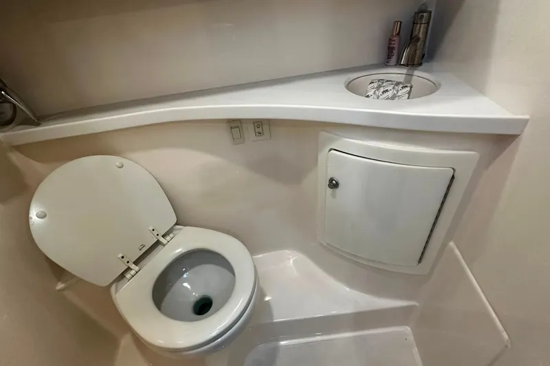 Slide: The Image of Compact bathroom in 2021 Regal 28 Express boat with toilet and sink. - 29
