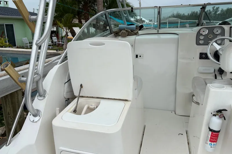 Slide: The Image of 2003 Wellcraft 270 Coastal I/O boat interior with seating, steering wheel, and safety equipment. - 6