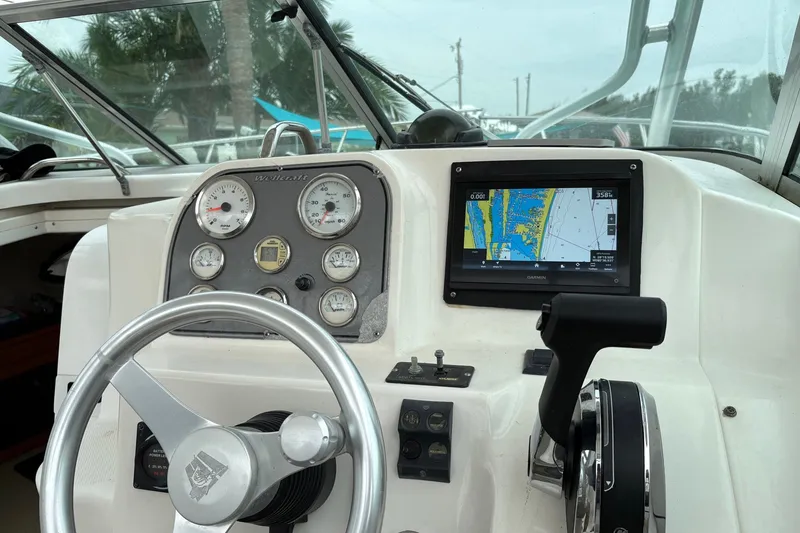 Slide: The Image of 2003 Wellcraft 270 Coastal I/O helm with gauges and Garmin navigation display. - 4
