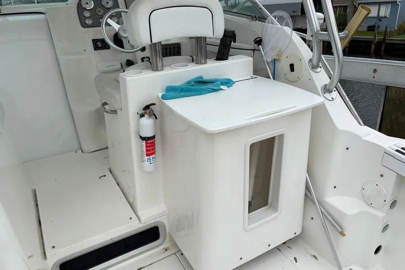 Slide: The Image of 2003 Wellcraft 270 Coastal I/O boat interior with helm, seat, and fire extinguisher. - 7