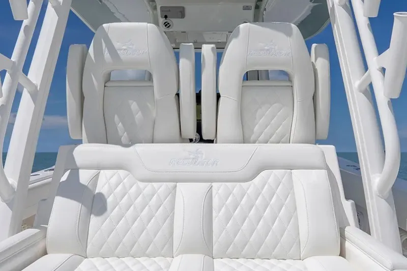 Slide: The Image of Luxurious white seating on a 2027 Regulator 31 boat, featuring diamond-pattern upholstery. - 7