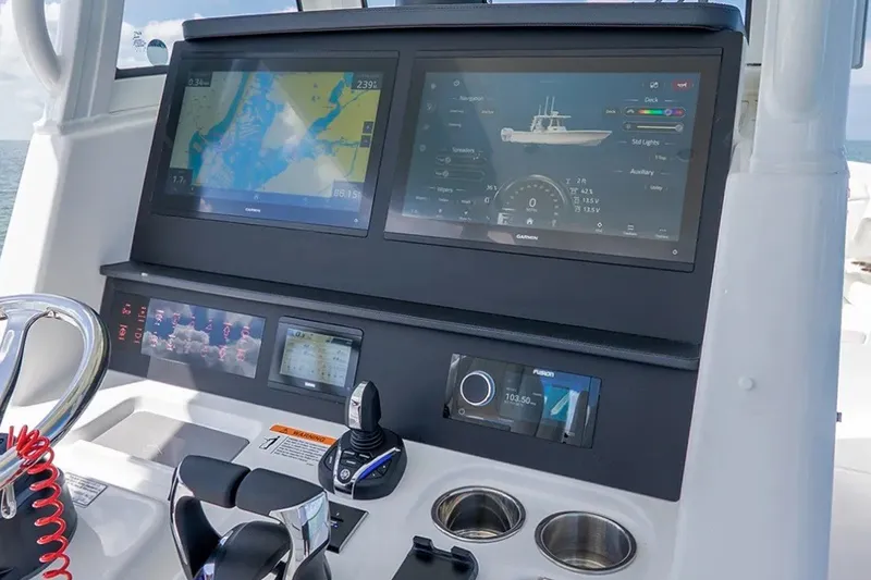 Slide: The Image of Helm of 2027 Regulator 31 boat with advanced navigation displays and controls. - 2