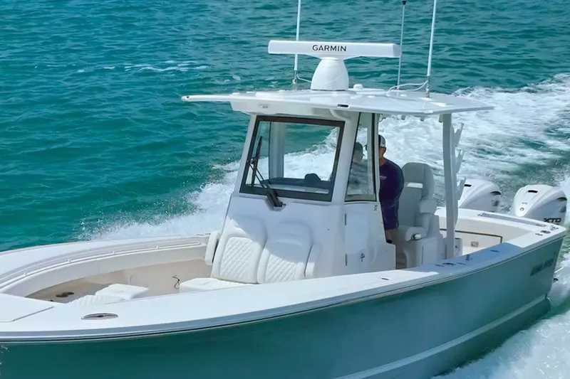 The Image of 2027 Regulator 31 boat cruising on clear blue water with Garmin equipment. - 0