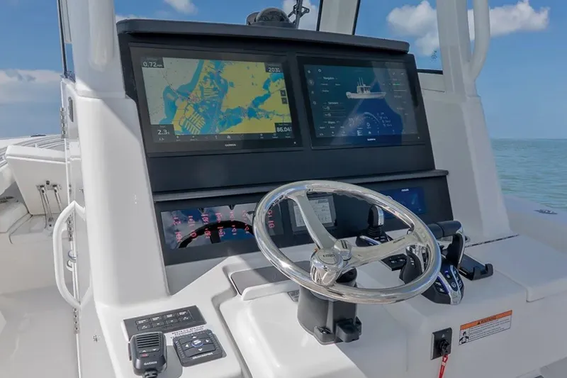 Slide: The Image of 2027 Regulator 31 boat dashboard with dual navigation screens and steering wheel. - 3