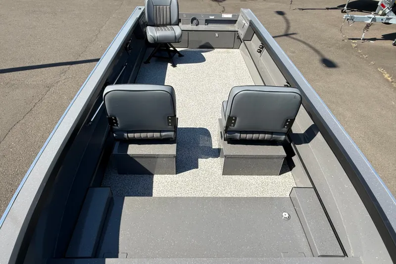 Slide: The Image of 2026 Alumaweld Free Drifter 20 boat interior with two gray seats on a speckled floor. - 20